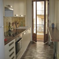 Kitchen decorated in yellow and dark wood